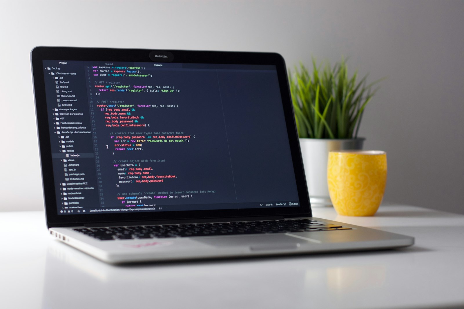 Developer working at a desk with code on screen